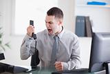 Businessman shouting at the phone