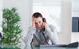 Businessman getting disappointing news on the phone