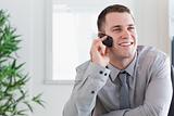 Businessman getting a pleasant call on his mobilephone