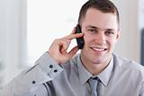 Smiling businessman getting good news on the phone