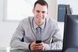 Businessman happy about a text message