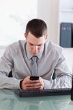 Close up of businessman reading text message