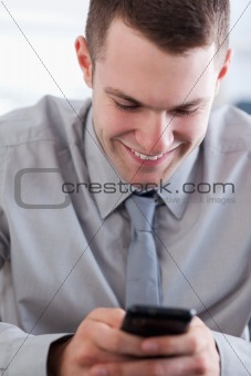 Close up of businessman getting a pleasant text message
