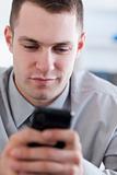 Close up of businessman reading text message on his cellphone