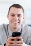 Close up of cellphone being held by smiling businessman