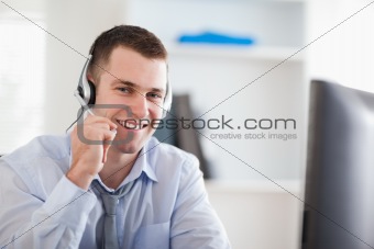 Smiling call center agent speaking with costumer