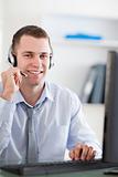 Close up of smiling call center agent speaking with costumer