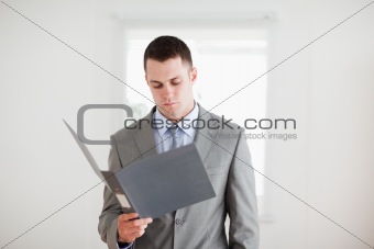 Businessman reading in his folder