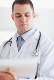 Close up of doctor checking notes