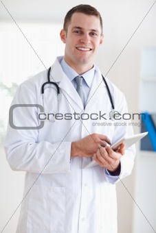 Close up of smiling doctor with notes