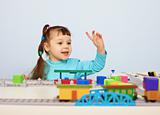 Child plays with a toy railroad