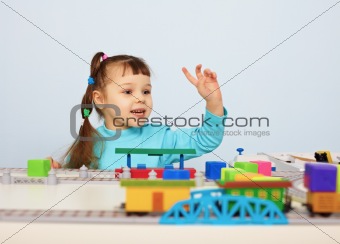 Child plays with a toy railroad