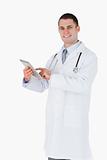 Smiling doctor using tablet computer