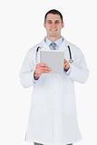 Smiling doctor using tablet pc