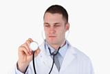 Close up of doctor looking at this stethoscope