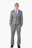Smiling businessman with hands in his pocket