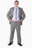 Smiling businessman with arms akimbo