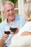 Happy Senior Man & Woman Couple Drinking Wine at Home