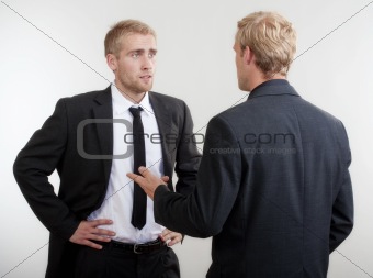 ywo you businessmen standing, discussing, arguing - isolated on light gray