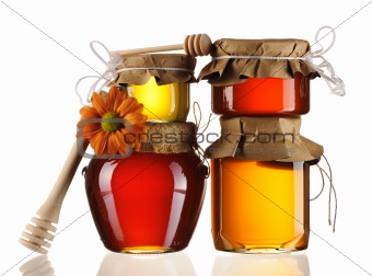 Jars of honey and dipper