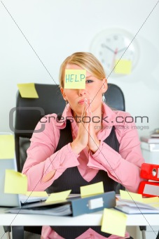 Begging for help modern female manager sitting at workplace covered with sticky notes 