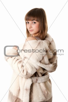 A beautiful young girl in a fur coat