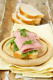 Delicious sandwich with ham on wooden table