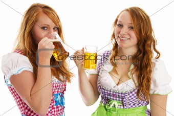 two bavarian girls laughing and drinking beer