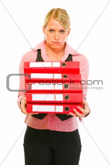 Tired of work modern female manager with pile of folders
