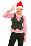 Cheerful female manager in Santa Hat showing ok gesture
