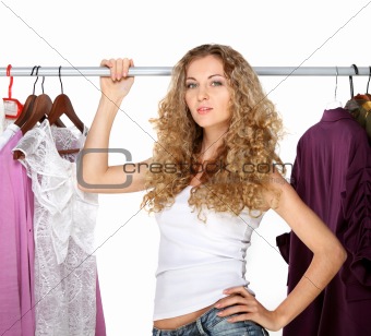 Portrait of a blonde beautiful girl selecting clothes 