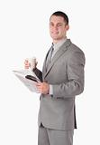 Portrait of a businessman holding a newspaper and a cup of tea