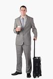 Portrait of a businessman holding a cup of tea and a suitcase