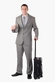 Portrait of a businessman holding a cup of coffee and a suitcase