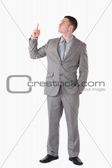 Portrait of a businessman pointing at a blank space