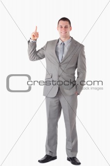 Portrait of a businessman pointing at a copy space