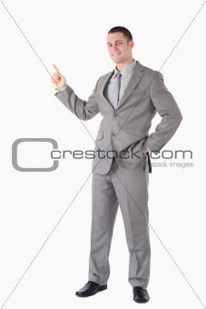 Portrait of a smiling businessman pointing at something