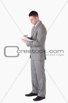 Portrait of a serious businessman taking notes