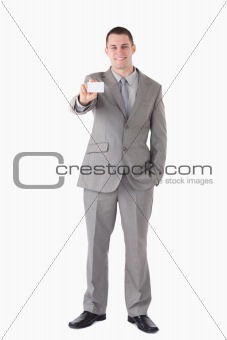 Portrait of a smiling businessman showing a business card
