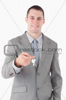 Portrait of a young businessman showing a set of keys