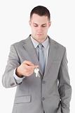 Portrait of a young businessman looking at a set of keys