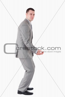 Portrait of a handsome young businessman carrying something