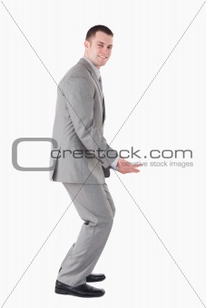 Portrait of a smiling businessman carrying something