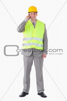 Portrait of a young builder making a phone call