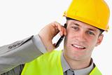 Close up of a young builder making a phone call