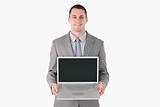 Smiling businessman showing a laptop