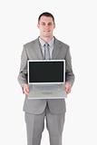 Portrait of a businessman showing a laptop