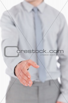 Portrait of a young businessman giving his hand