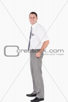 Portrait of a young office worker with the hands on his pockets