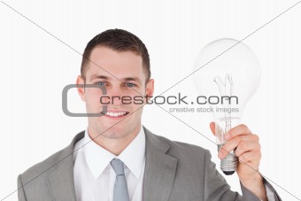 Businessman holding a bulb